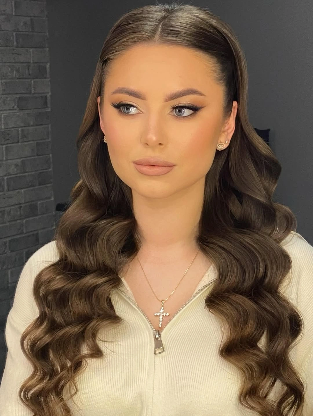 Long brunette hair with center part and symmetrical waves