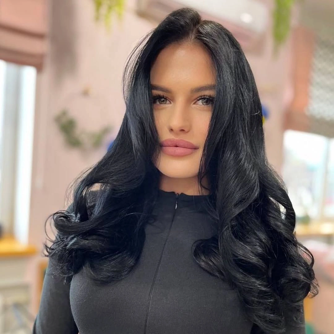 Long black hair with center part and outward-curving curls