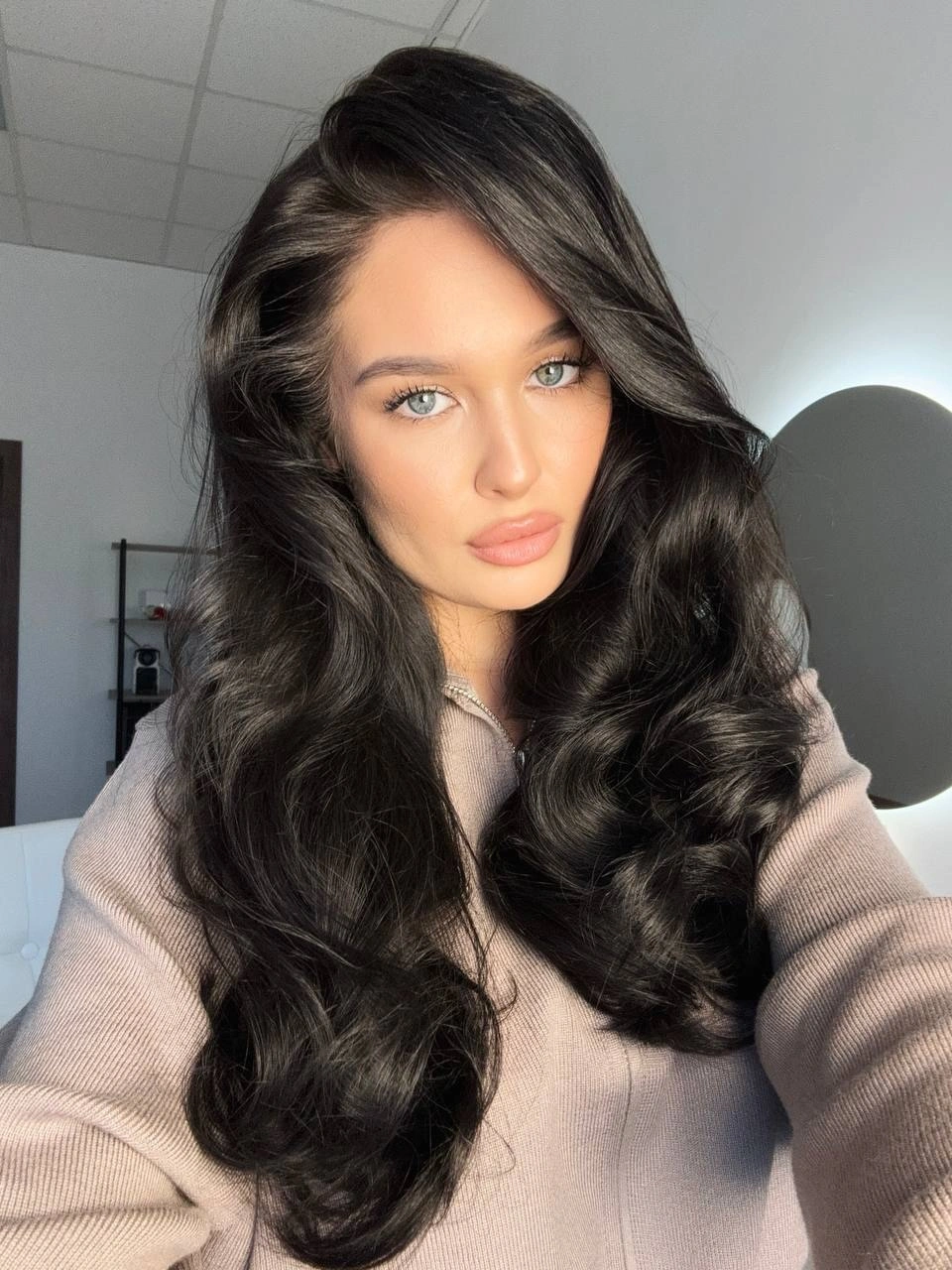 Very long dark hair with deep side part and large curls