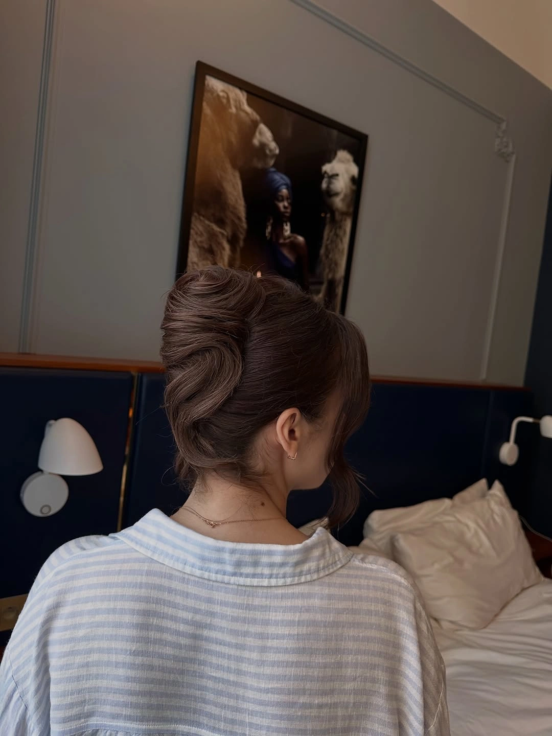 Brown hair in a tall vertically gathered looped updo