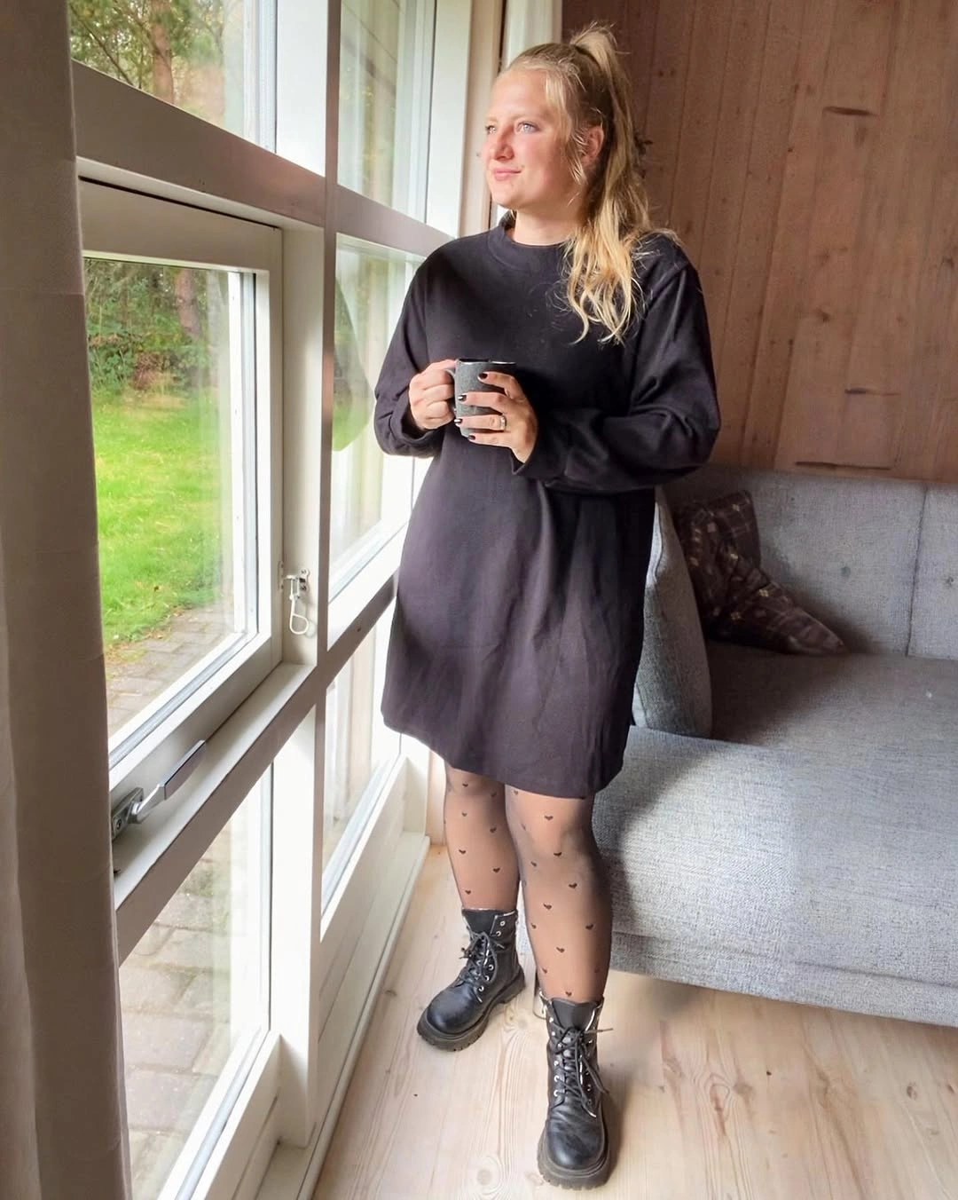 Oversized black longline top with dotted sheer tights and lace up boots