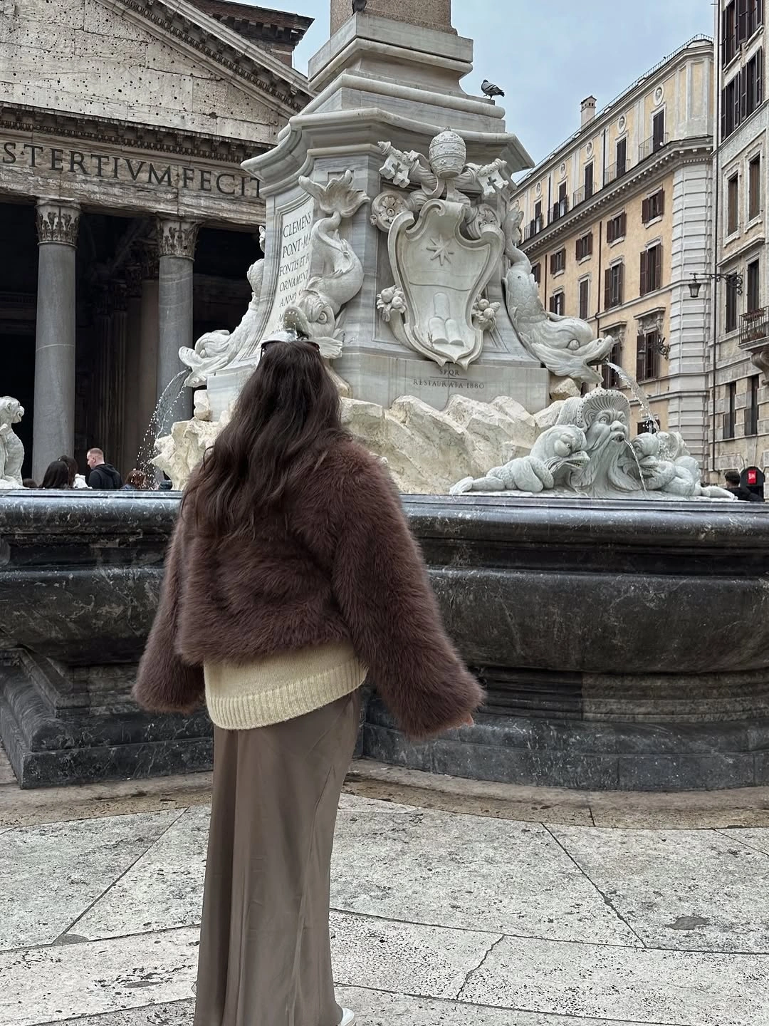 Cropped plush brown jacket over cream ribbed layer and long taupe garment