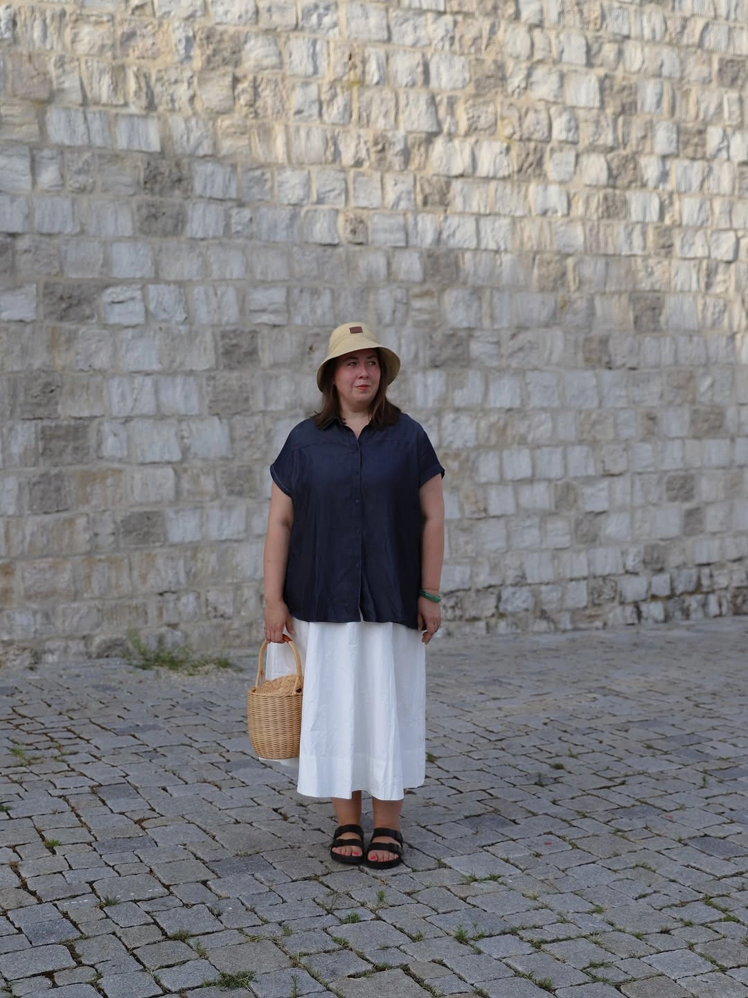 Navy short sleeve button front shirt with white skirt and woven basket