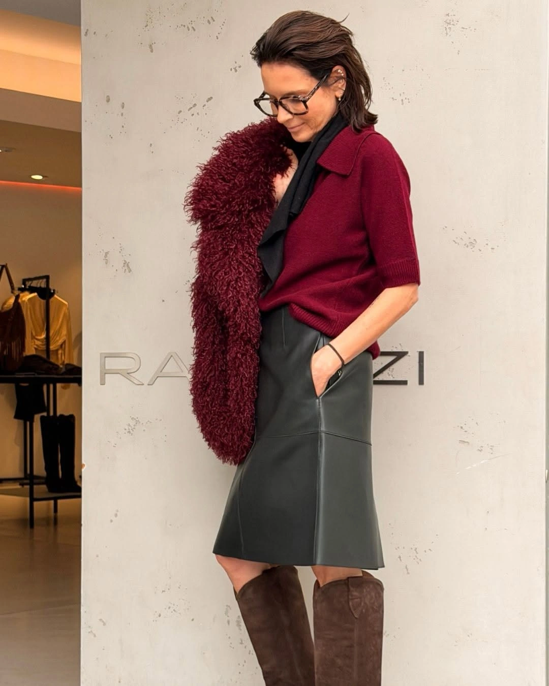 Burgundy top dark skirt tall brown boots and fuzzy layer
