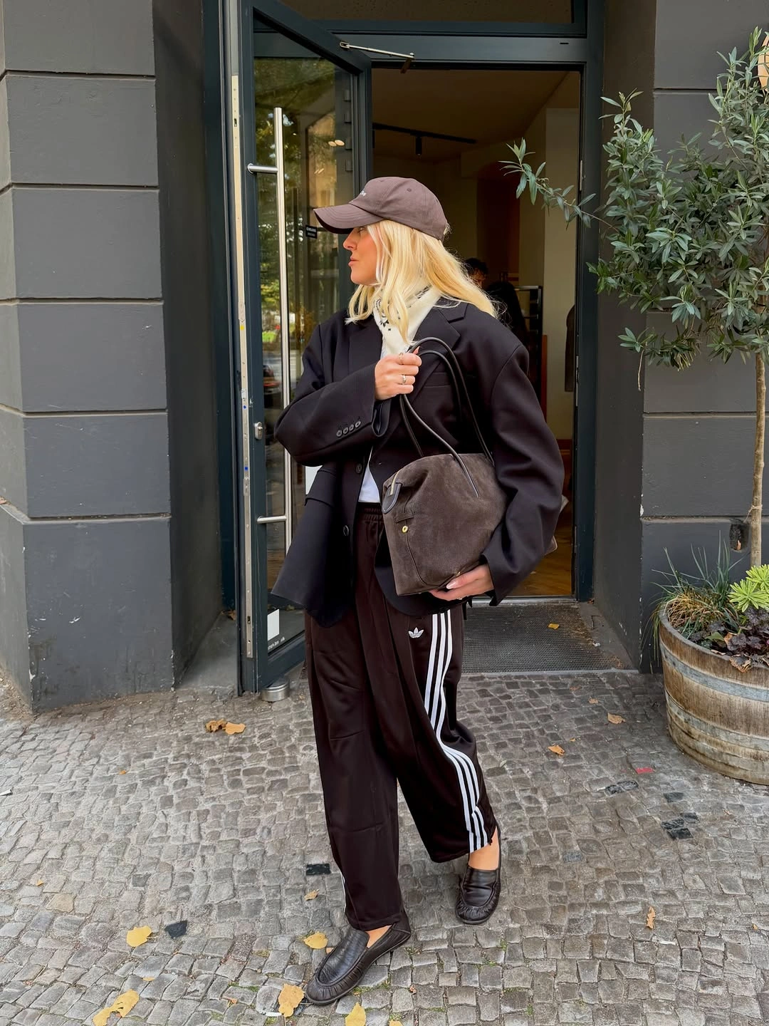 Black blazer striped track trousers loafers and brown bag