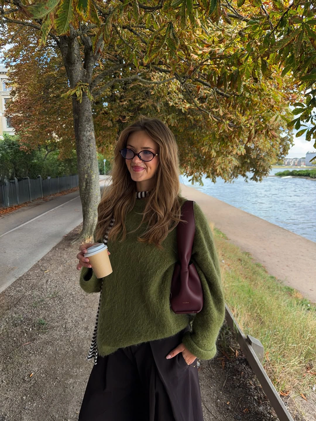Olive fuzzy sweater wide black trousers and burgundy bag