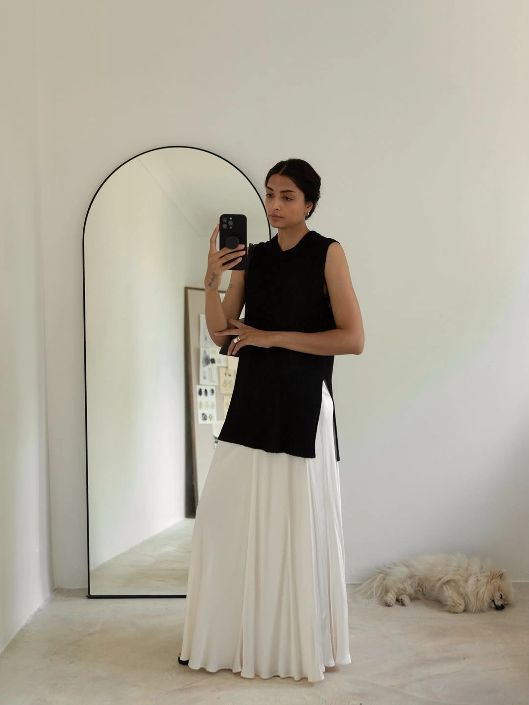 Black sleeveless top over flowing white floor-length layer