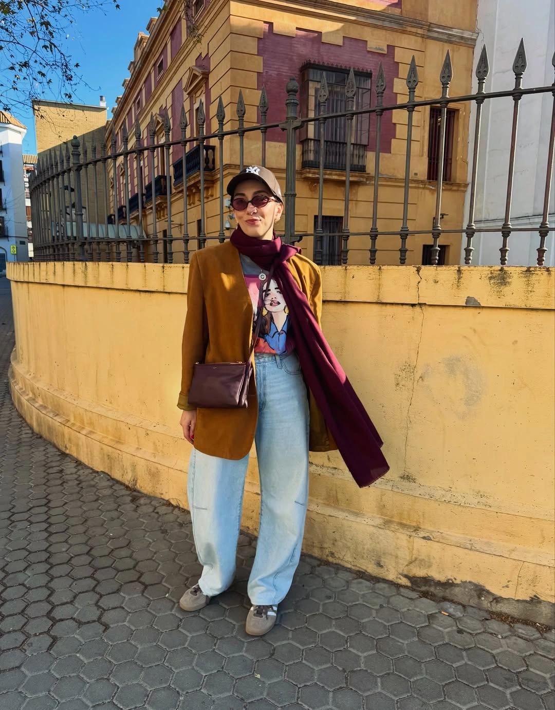 Ochre blazer pale jeans burgundy scarf and crossbody bag