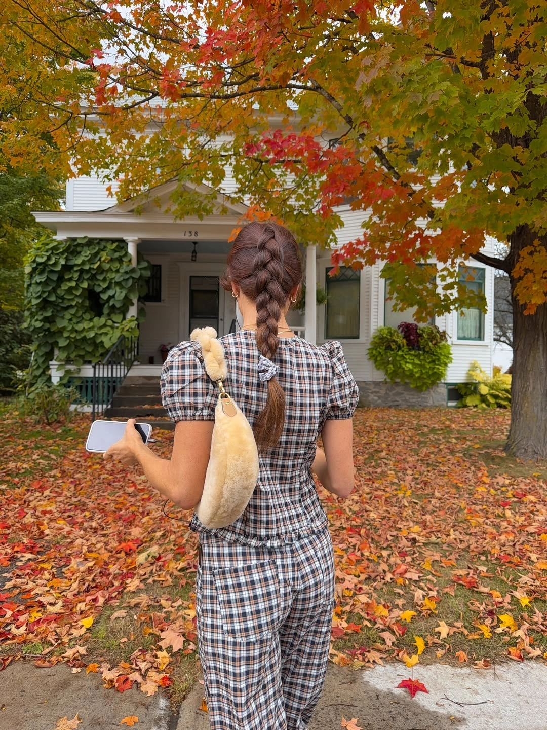 Brown plaid outfit with puff sleeves and plush shoulder bag