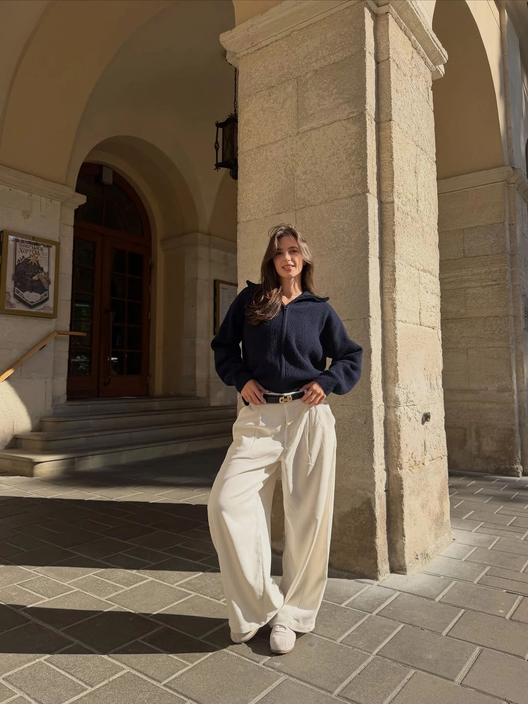 Navy textured top with wide cream trousers and white sneakers