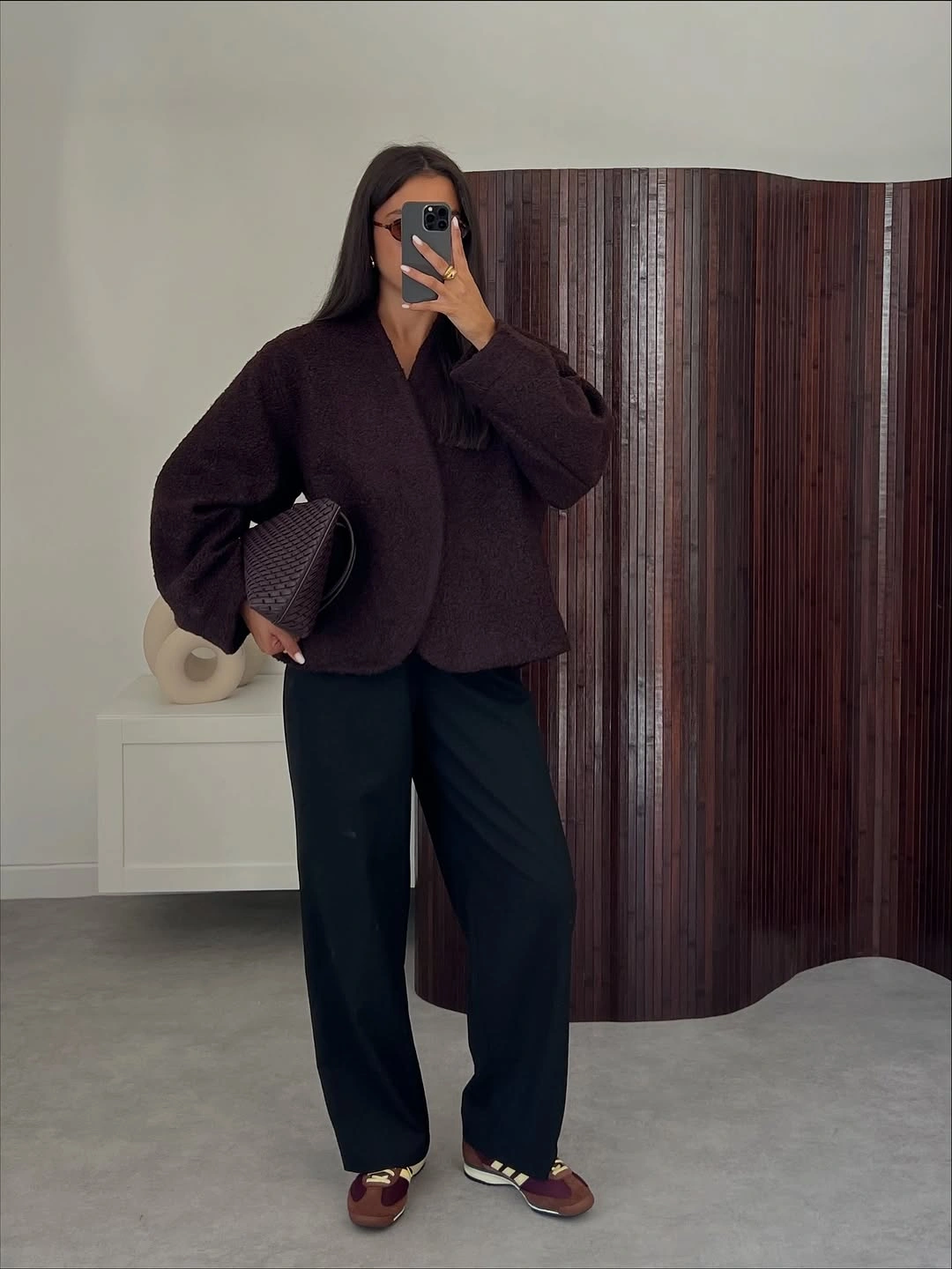 Roomy plum top with dark wide trousers and burgundy sneakers
