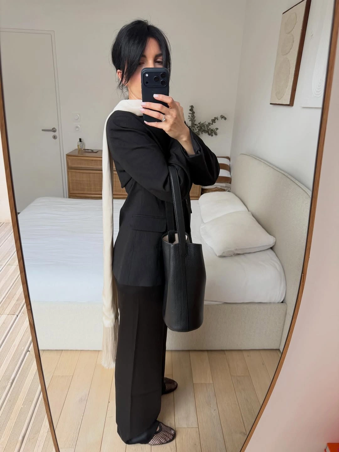Black blazer and wide trousers with long off-white scarf and tote