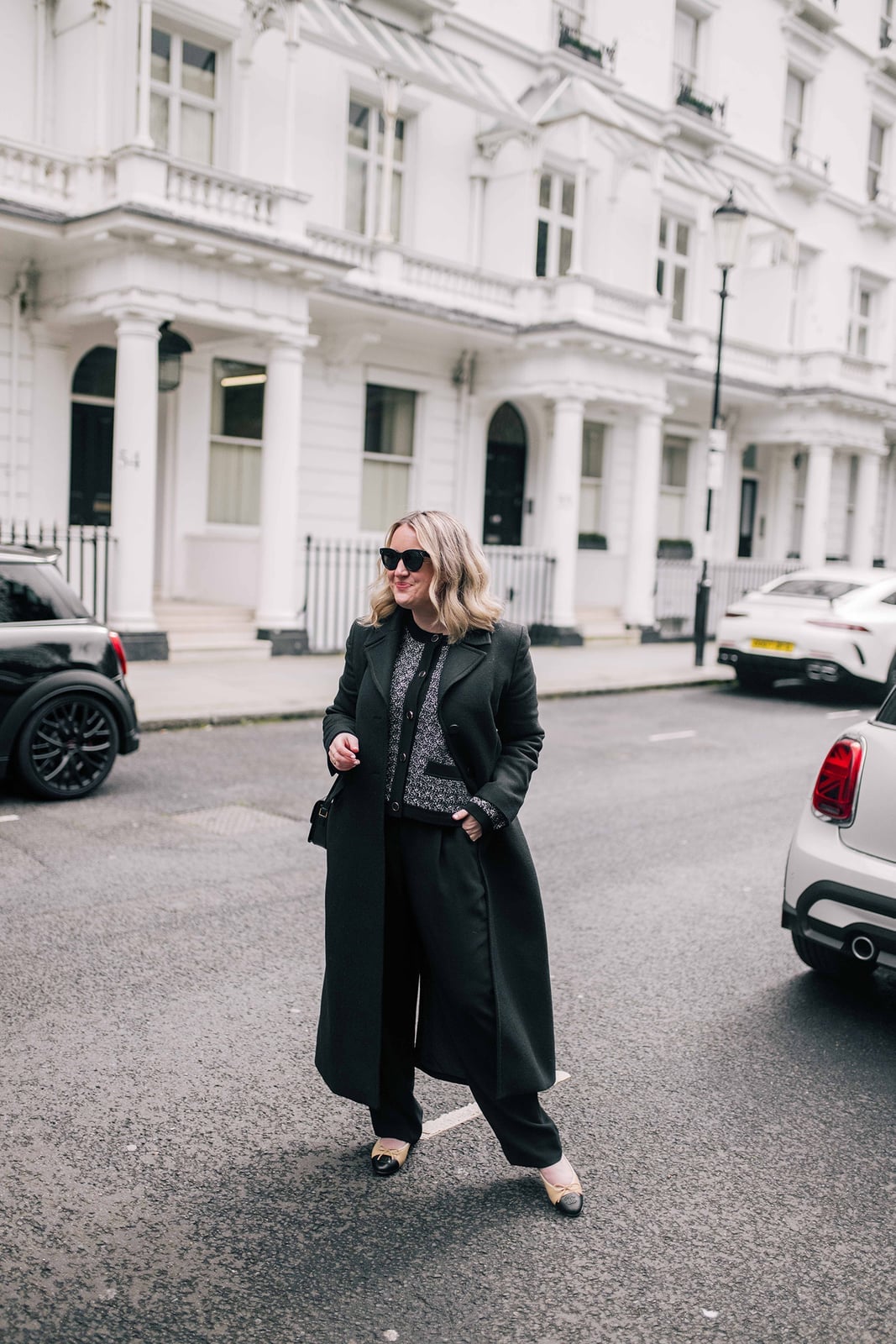 Black and White Patterned Top with Black Coat and Wide-Leg Trousers — Aesthetic Black Sweater Outfit