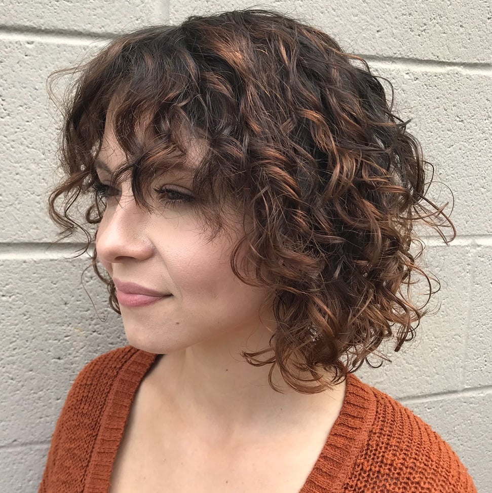 Collarbone Bob With Curtain Bangs And Auburn Highlights Collarbone Bob With Curtain Bangs And Auburn Highlights — Classy Bob with Curls