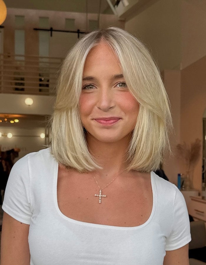 Platinum Blonde Bob With Sharp Lines And Curtain Bangs Platinum Blonde Bob With Sharp Lines And Curtain Bangs — Classy Bob with Curtain Bangs