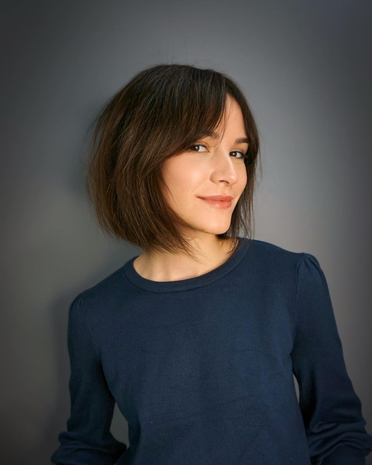 Chin Length Bob With Textured Dark Brown Waves, Close-Up Take Chin Length Bob With Textured Dark Brown Waves, Close-Up Take — Classy Bob with Curtain Bangs