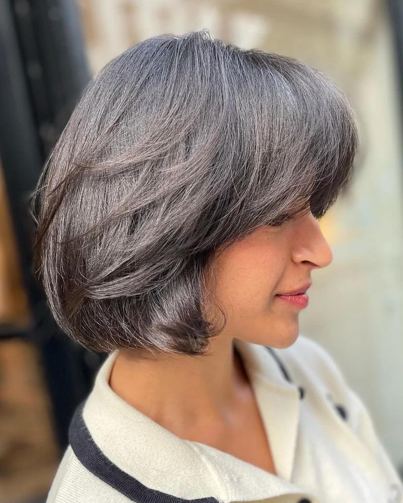 Side View Chin Bob With Light Brown Wavy Texture And Curtain Bangs Side View Chin Bob With Light Brown Wavy Texture And Curtain Bangs — Classy Bob with Curtain Bangs