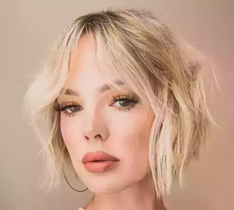 Chin Length Ash Blonde Bob With Wavy Blowout, Close-Up Take Chin Length Ash Blonde Bob With Wavy Blowout, Close-Up Take — Classy Bob with Curtain Bangs