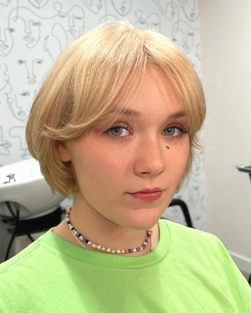 Chin Length Ash Blonde Bob With Voluminous Blowout And Curtain Bangs Chin Length Ash Blonde Bob With Voluminous Blowout And Curtain Bangs — Classy Bob with Curtain Bangs