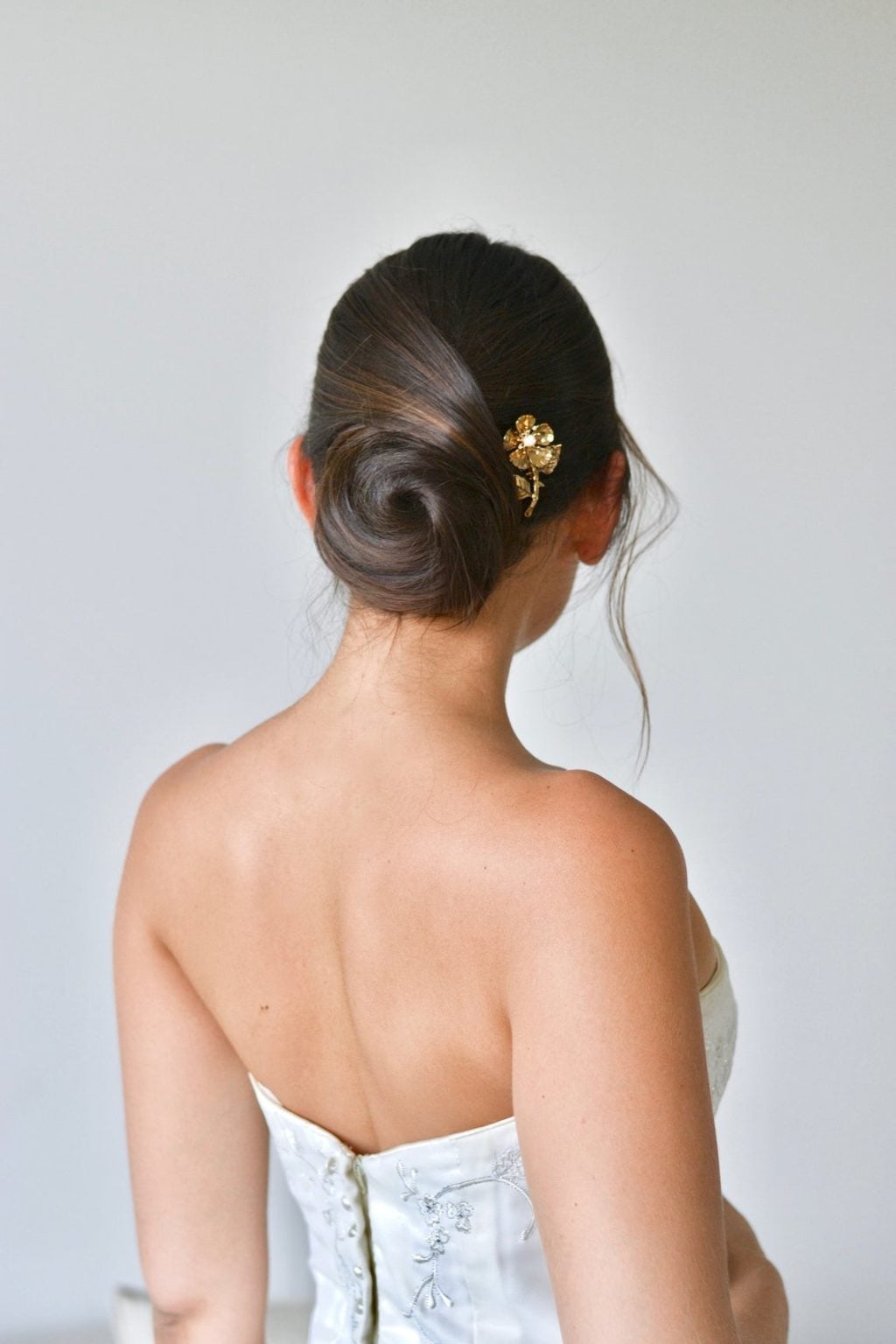 Dark Brown Low Bun With Gold Pin Dark Brown Low Bun With Gold Pin — Classy Bridal Bun