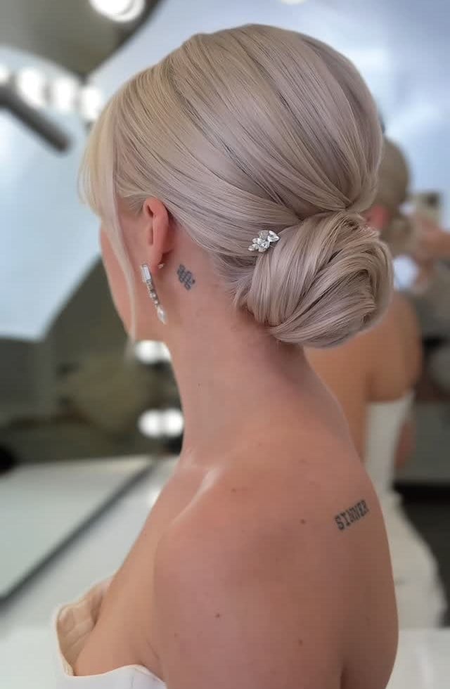Platinum Blonde Sleek Low Bun With Accessory Platinum Blonde Sleek Low Bun With Accessory — Classy Bridal Bun