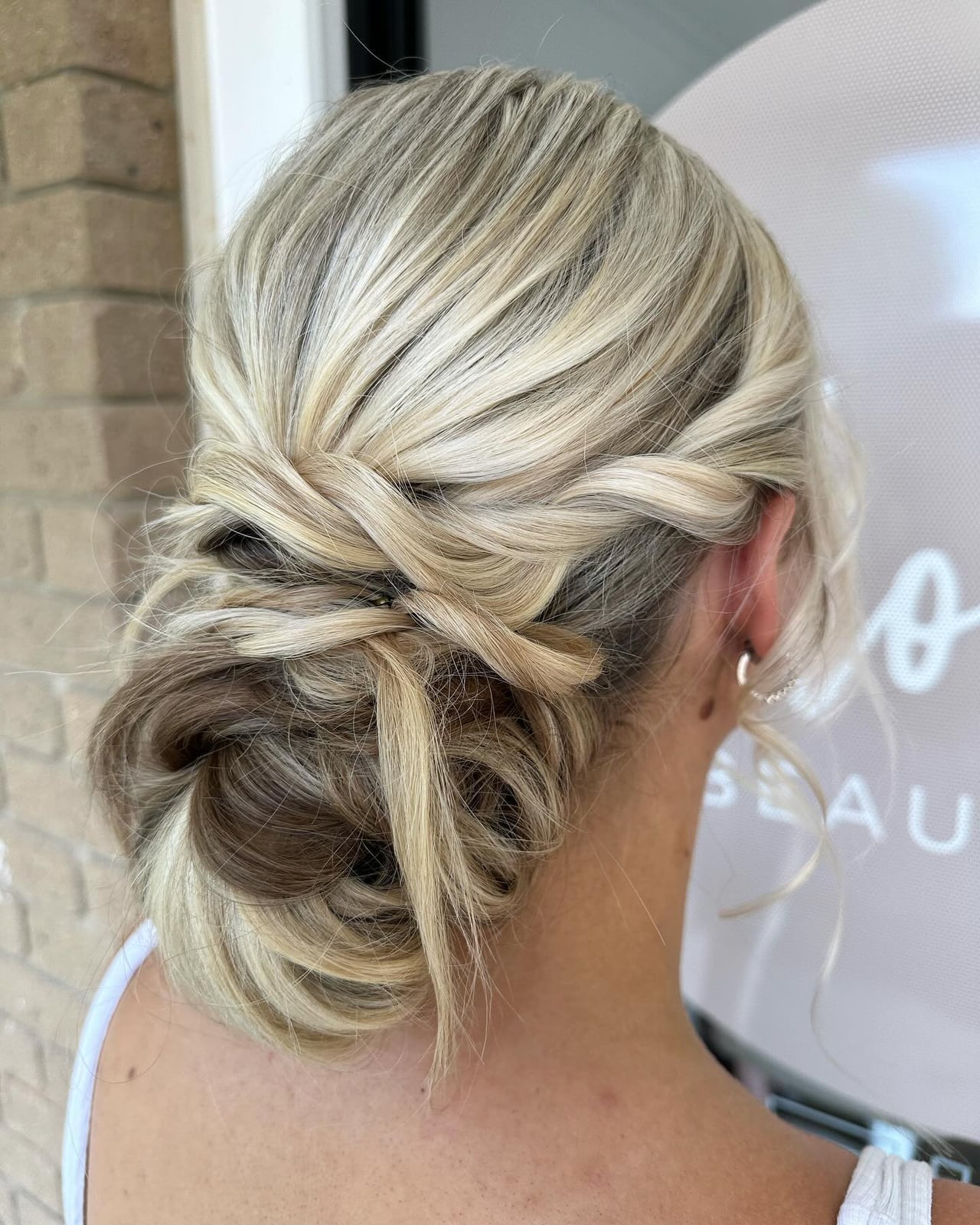 Ash Blonde Low Bun With Braided Accents Ash Blonde Low Bun With Braided Accents — Classy Casual Updo
