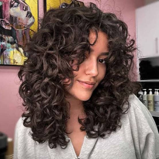 Blonde Curly Wolf Cut With Curly Bangs Blonde Curly Wolf Cut With Curly Bangs — Classy Curly Wolf Cut