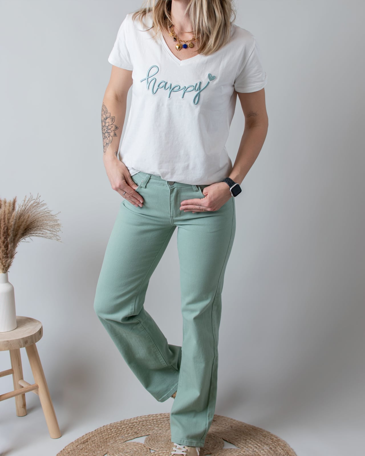 Green Straight Leg Jeans with a White V-neck T-Shirt and Gold Sneakers Green Straight Leg Jeans with a White V-neck T-Shirt and Gold Sneakers — Classy Green Jeans Outfits