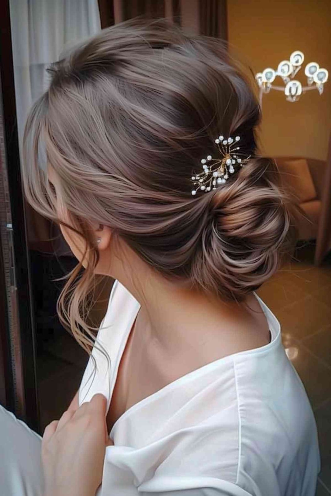 Ash Brown Wavy Bun With Wispy Bangs Ash Brown Wavy Bun With Wispy Bangs — Classy Low Bun Wedding Hair