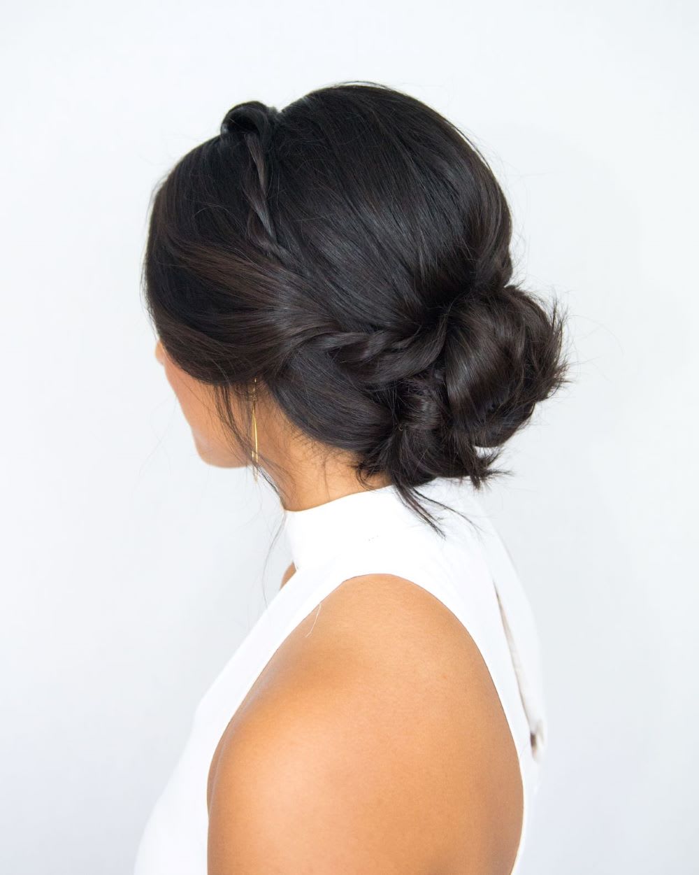 Dark Brown Braided Crown Accents Side View Dark Brown Braided Crown Accents Side View — Classy Low Bun Wedding Hair