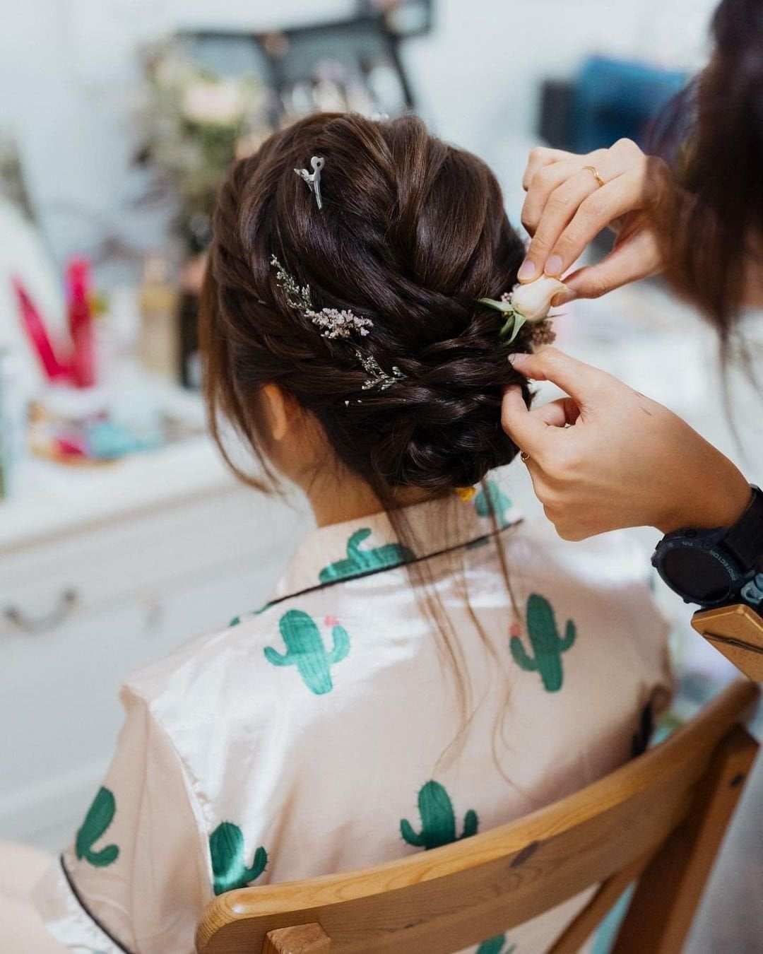 Dark Brown Braided Updo With Floral Accents Dark Brown Braided Updo With Floral Accents — Classy Low Bun Wedding Hair