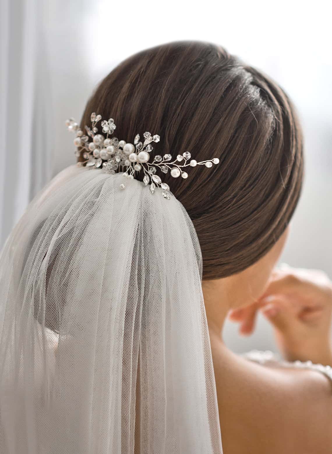 Dark Brown Sleek Bun With Bridal Accessory Dark Brown Sleek Bun With Bridal Accessory — Classy Low Bun Wedding Hair