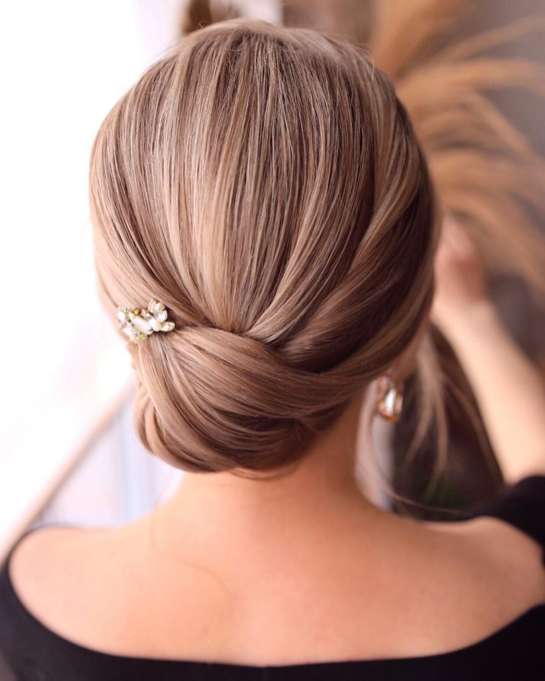 Brown Twisted Low Updo With Jewel Brown Twisted Low Updo With Jewel — Classy Low Bun Wedding Hair