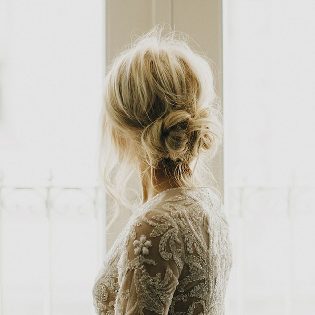 Platinum Blonde Textured Low Bun With Floral Pins Platinum Blonde Textured Low Bun With Floral Pins — Classy Low Bun Wedding Hair