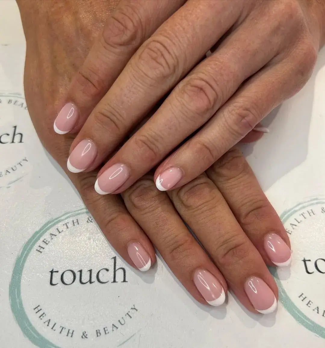 Sheer Pink Base White French Tip Short Oval Nails, Close-Up Take Sheer Pink Base White French Tip Short Oval Nails, Close-Up Take — Classy Mom Nails