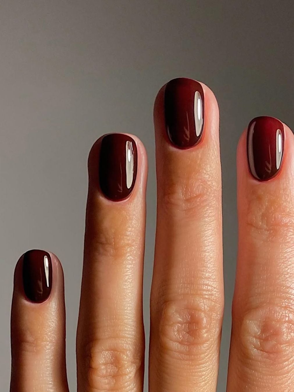 Deep Glossy Burgundy Short Oval Nails, Close-Up Take Deep Glossy Burgundy Short Oval Nails, Close-Up Take — Classy Nail Colors