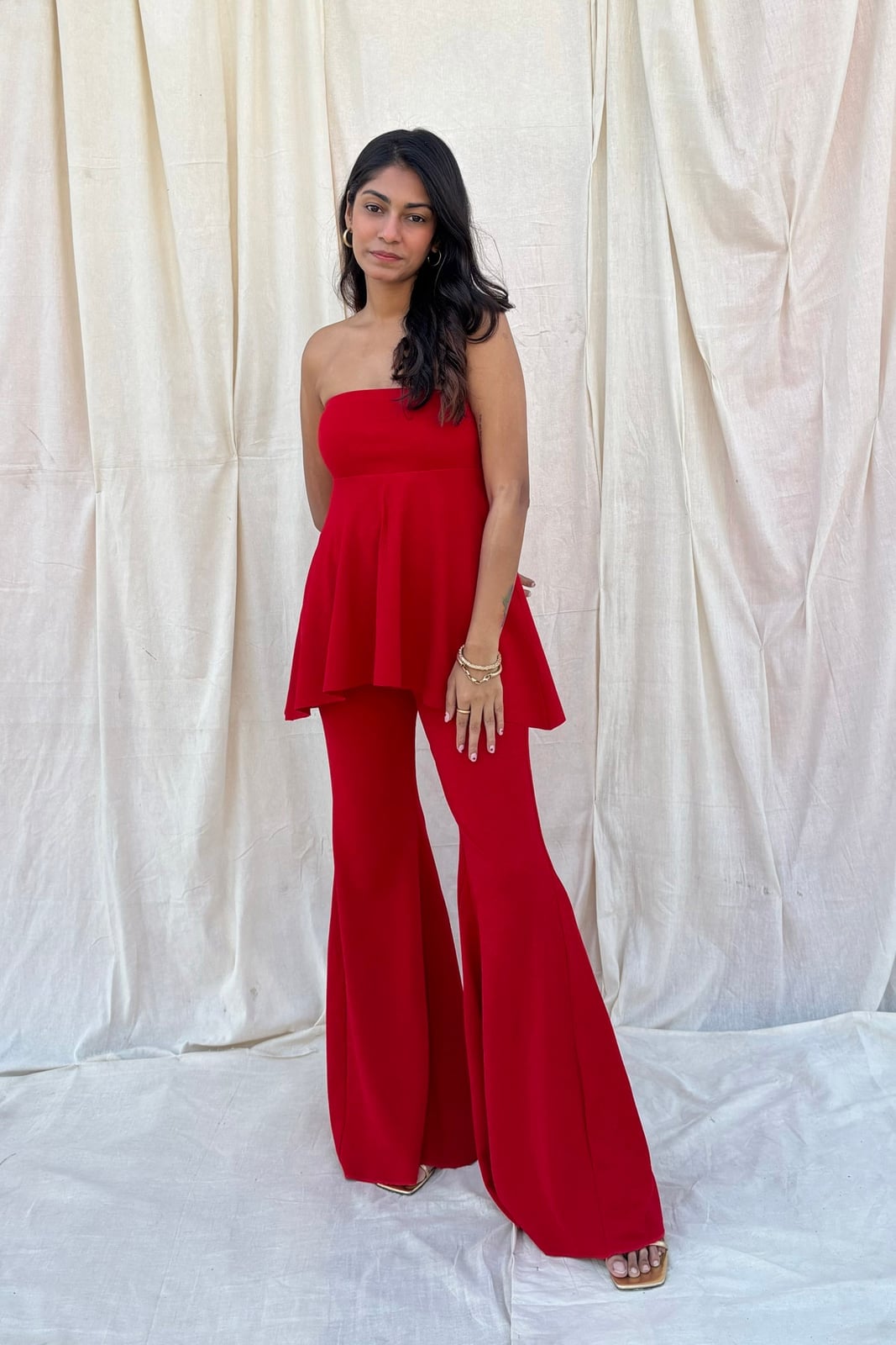 Red Flared Trousers With Strapless Peplum Top and Gold Strappy Sandals — Classy Red Pants Outfits