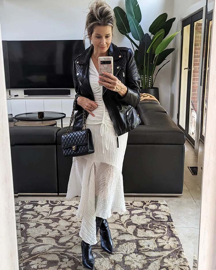 Black Leather Biker Jacket Over White Asymmetrical Dress — Classy Rock Concert Outfits