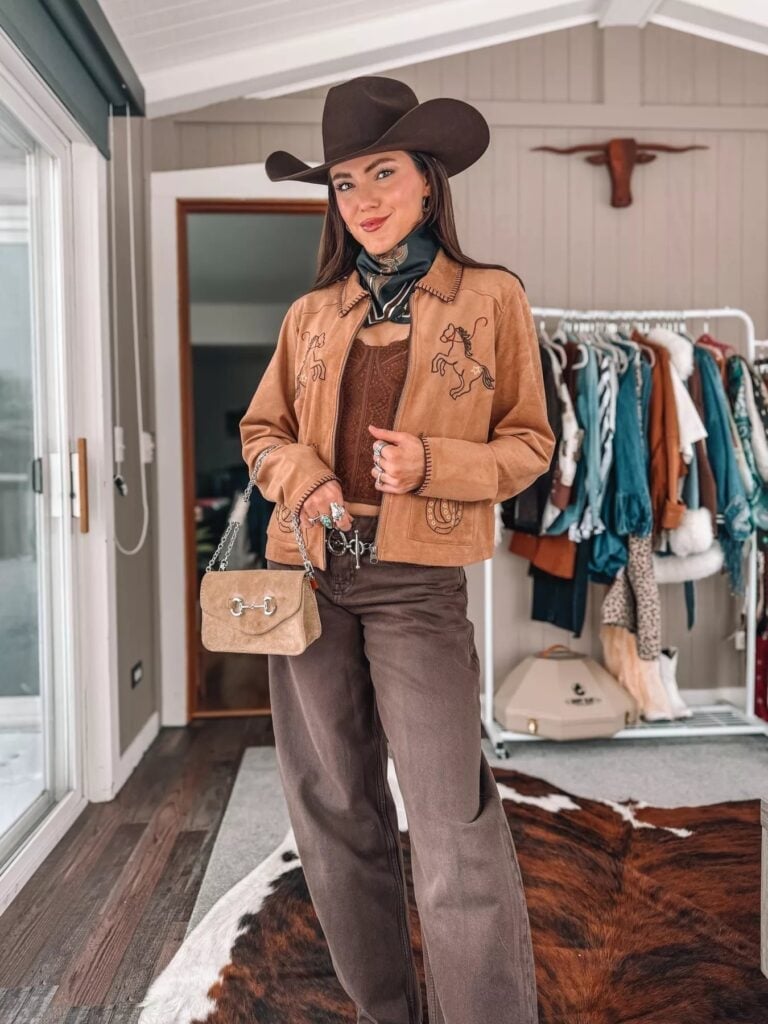 Tan Suede Jacket With Horse Embroidery and She Wears A Cowboy Hat — Classy Rodeo Outfits for Women