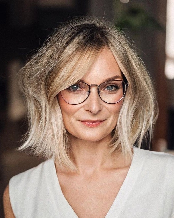 Wavy Ash Blonde Bob With Soft Side Bangs Wavy Ash Blonde Bob With Soft Side Bangs — Classy Side Part Bangs