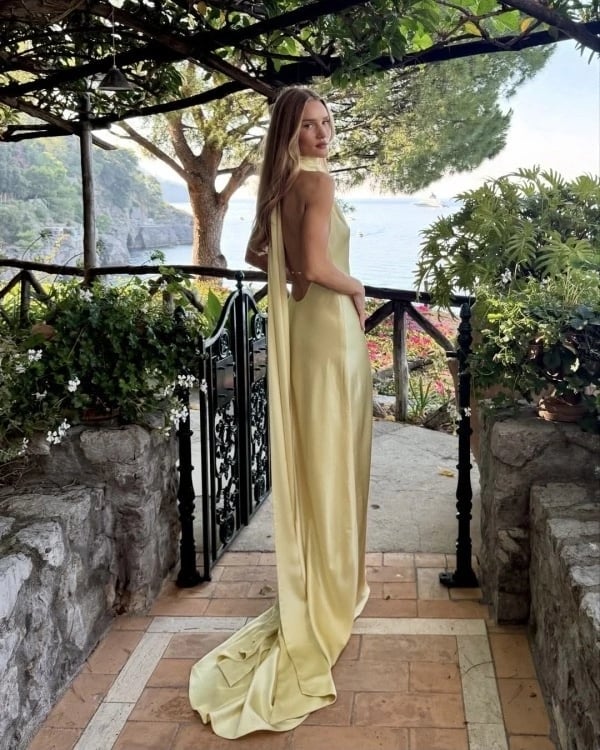 Pale Yellow Satin Backless Gown with Draped Back Detail Pale Yellow Satin Backless Gown with Draped Back Detail — Classy Wedding Guest Outfits
