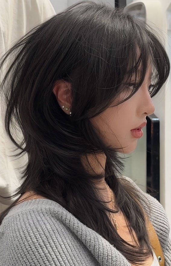 Bold and Stylish Wolf Haircut Ideas : Soft Black Layered Wolf Cut