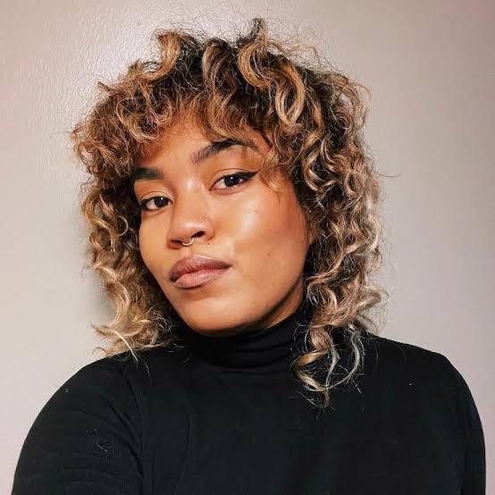 Thick Curly Collarbone Wolf Cut With Full Bangs Thick Curly Collarbone Wolf Cut With Full Bangs — Classy Wolf Cut Hair