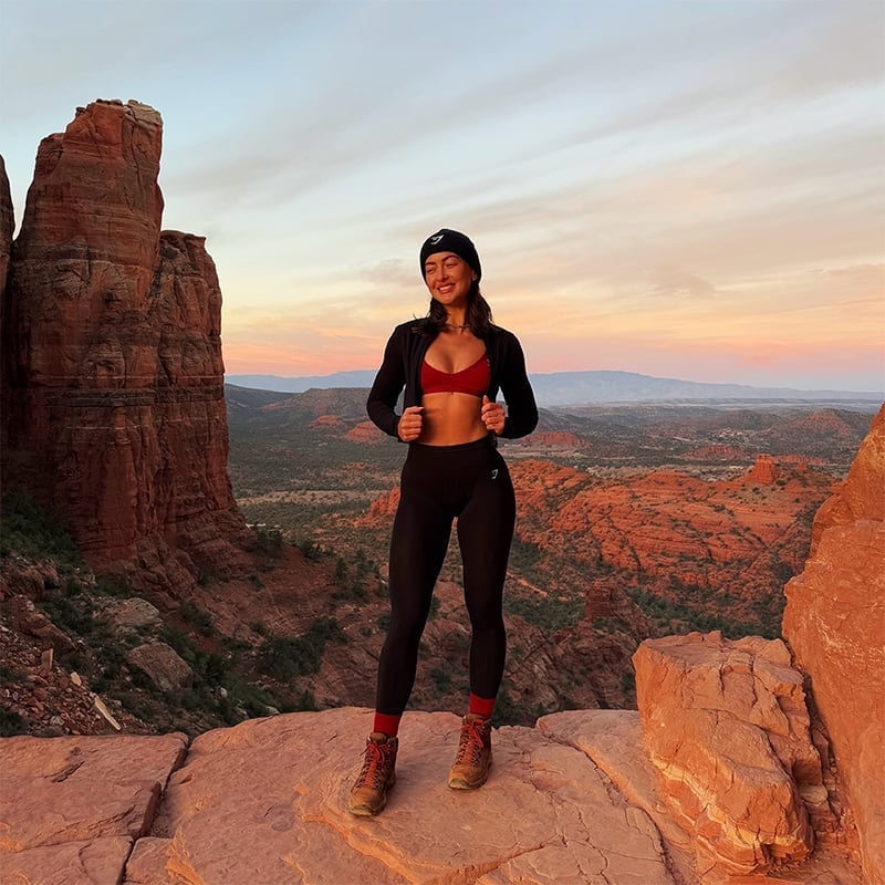 Black Leggings With Red Sports Bra And Zip-Up Jacket — Cute Hiking Outfit Inspo
