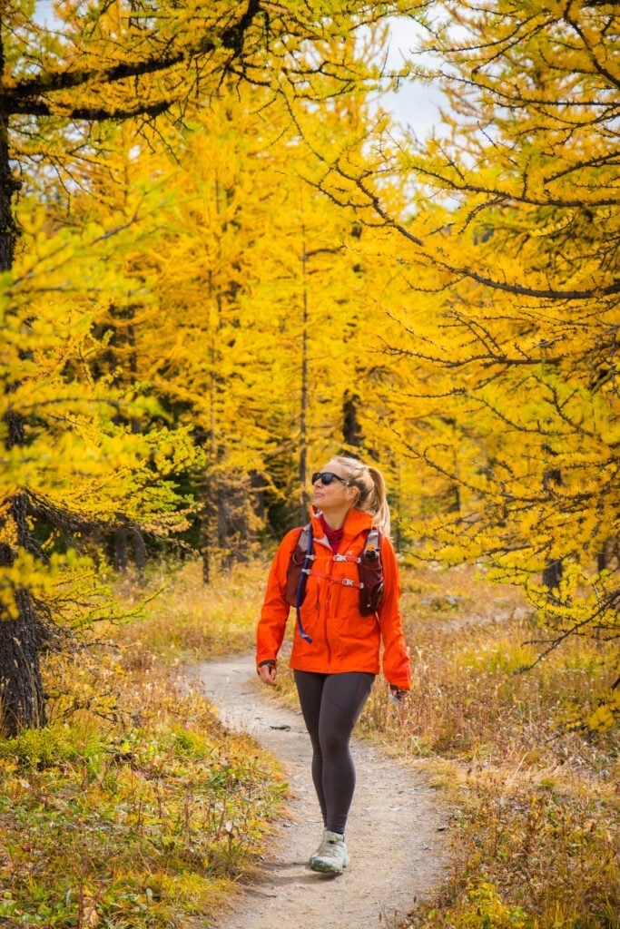 Orange Jacket Over Red Base Layer And Grey Leggings — Cute Hiking Outfit Inspo