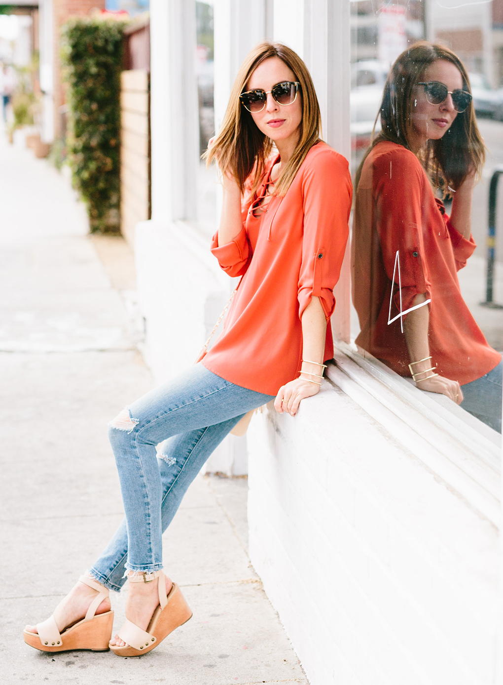 Distressed Light Wash Skinny Jeans with an Orange Blouse — Cute Jeans Outfit Inspo