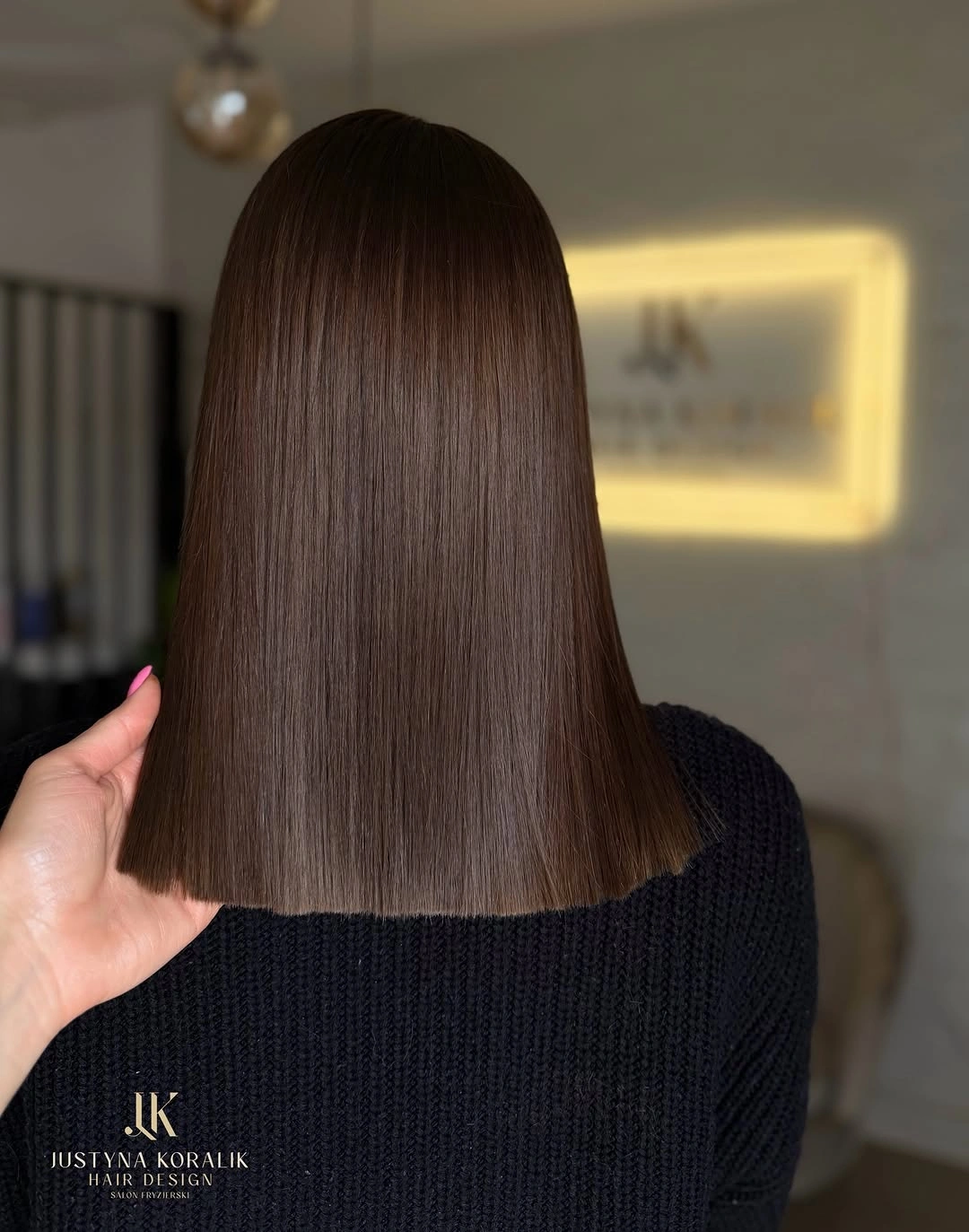 Straight medium brown hair with a precise shoulder-length blunt edge