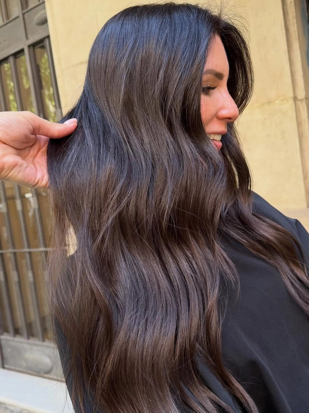 Very long dark wavy hair with cool blue-violet reflections