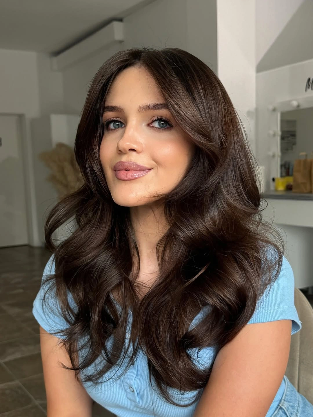 Long dark chocolate brown hair with rounded face-framing waves