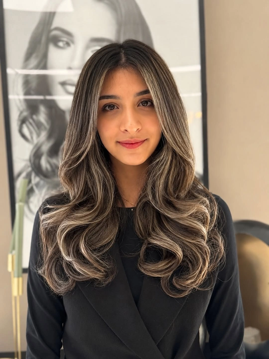 Long dark brunette layered waves with smoky beige face-framing highlights